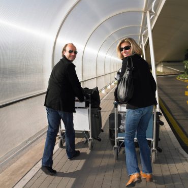 Couple with luggage on a trolley