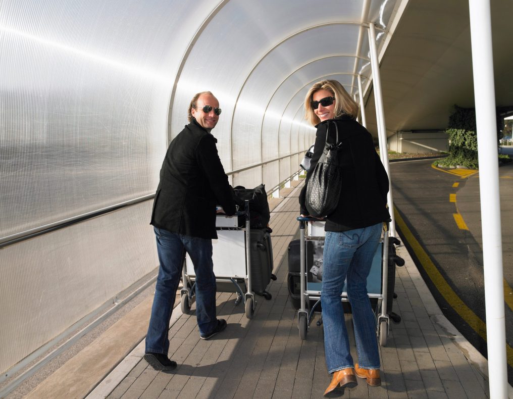 Couple with luggage on a trolley